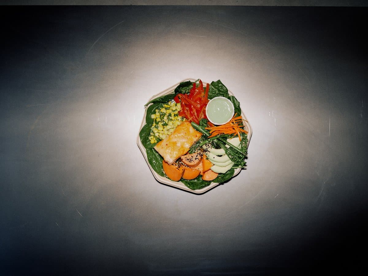Feed Your Brain plate with seared fish, avocado, sweet potato, and lime